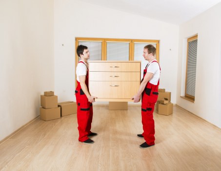 Professional movers handling stairs in a North London flat